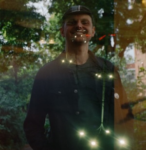 Picture of James O'Shea, software developer. There is an artistic double-exposure effect, as the film camera used was broken.